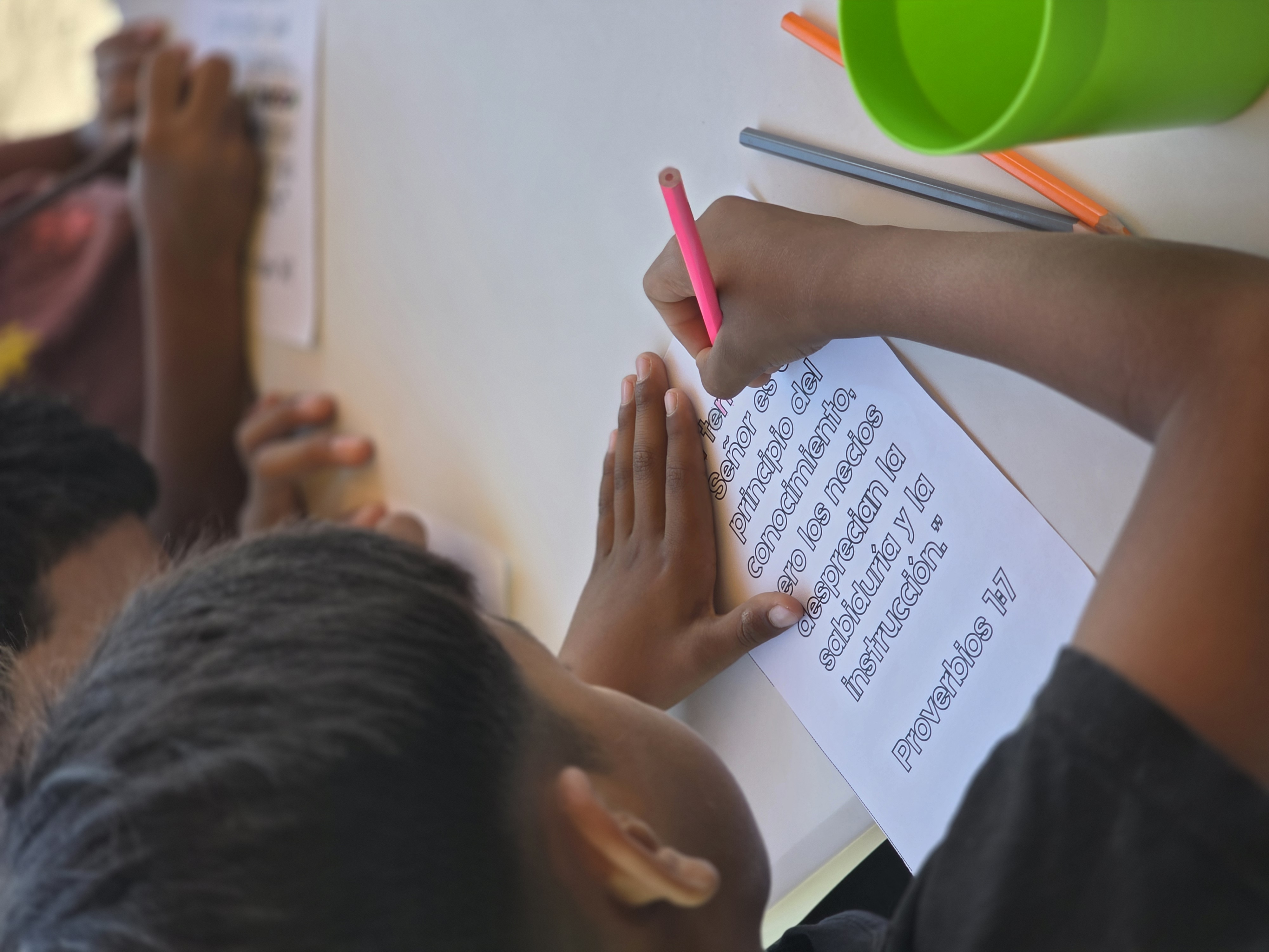 A child completing a Bible lesson worksheet